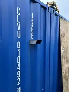 Original rear-facing flue outlet on container housing a Nilfisk Truck Booster before vertical chimney installation in Lichfield.